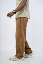 Man wearing corduroy baggy pants with a jersey for a casual streetwear look and all-day comfort