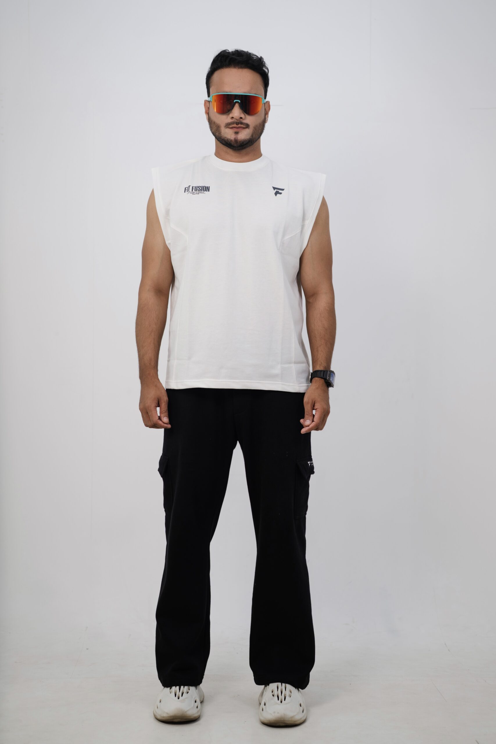 Man wearing sleeveless t shirt for gym styled with joggers